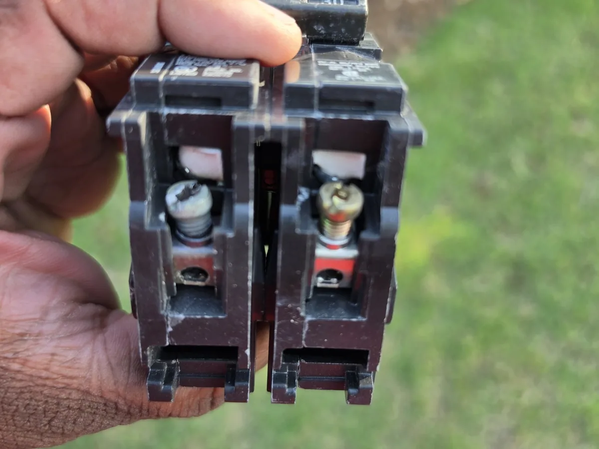 Circuit breaker being inspected during electrical troubleshooting