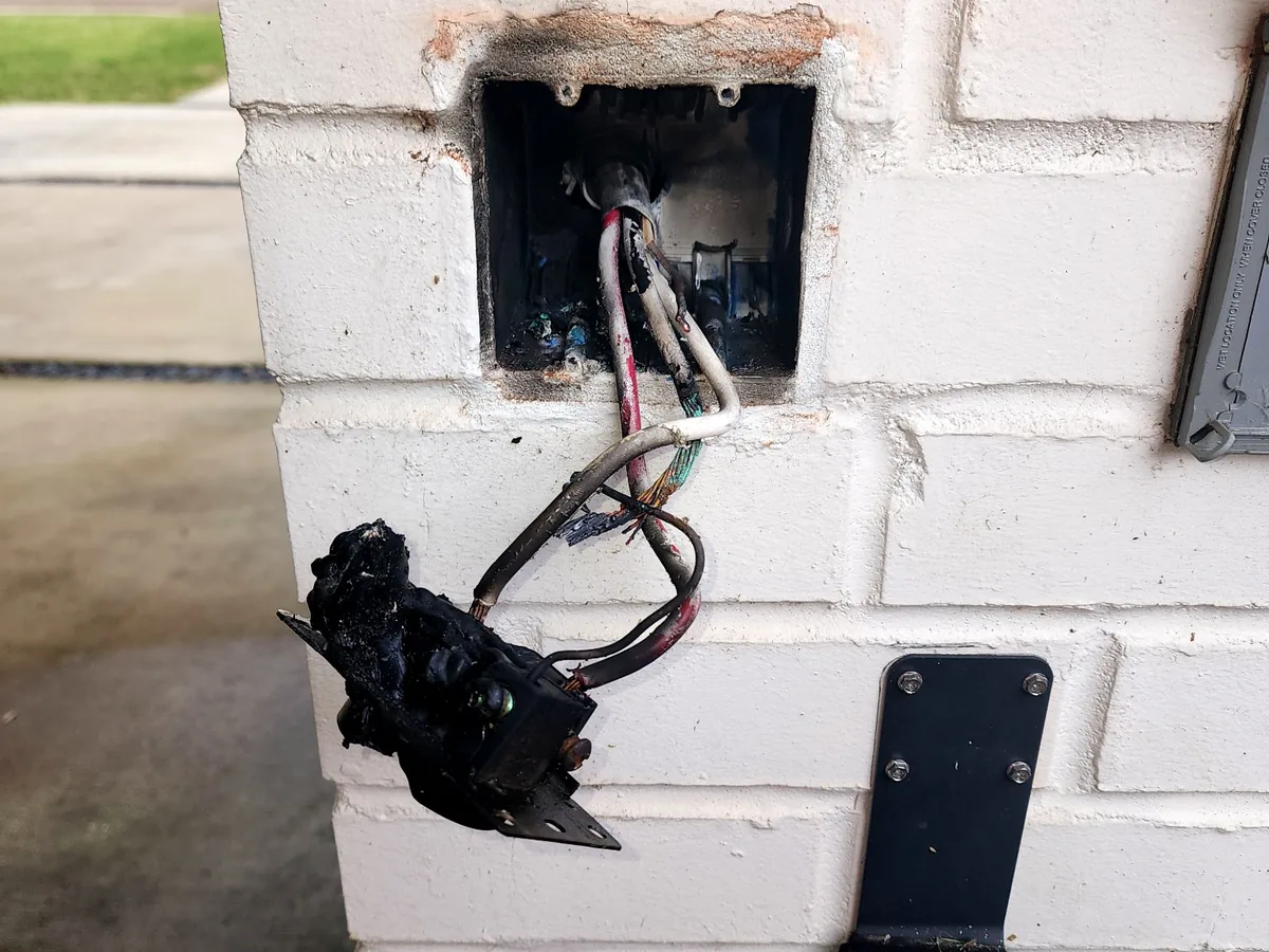 Burned wiring and electrical box on an exterior wall