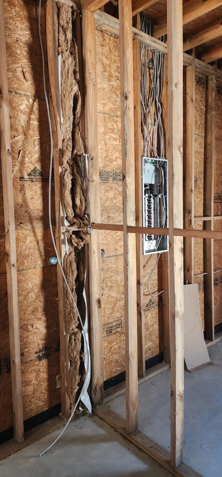 Electrical panel and house wiring in exposed wall framing